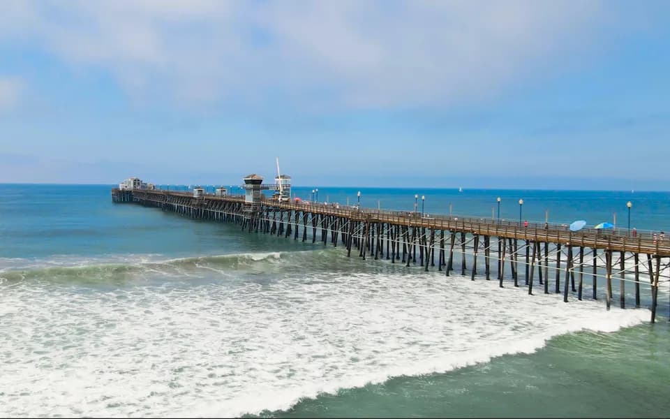 Waves rolling under the Oceanside Pier from above